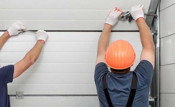 Men installing a garage door
